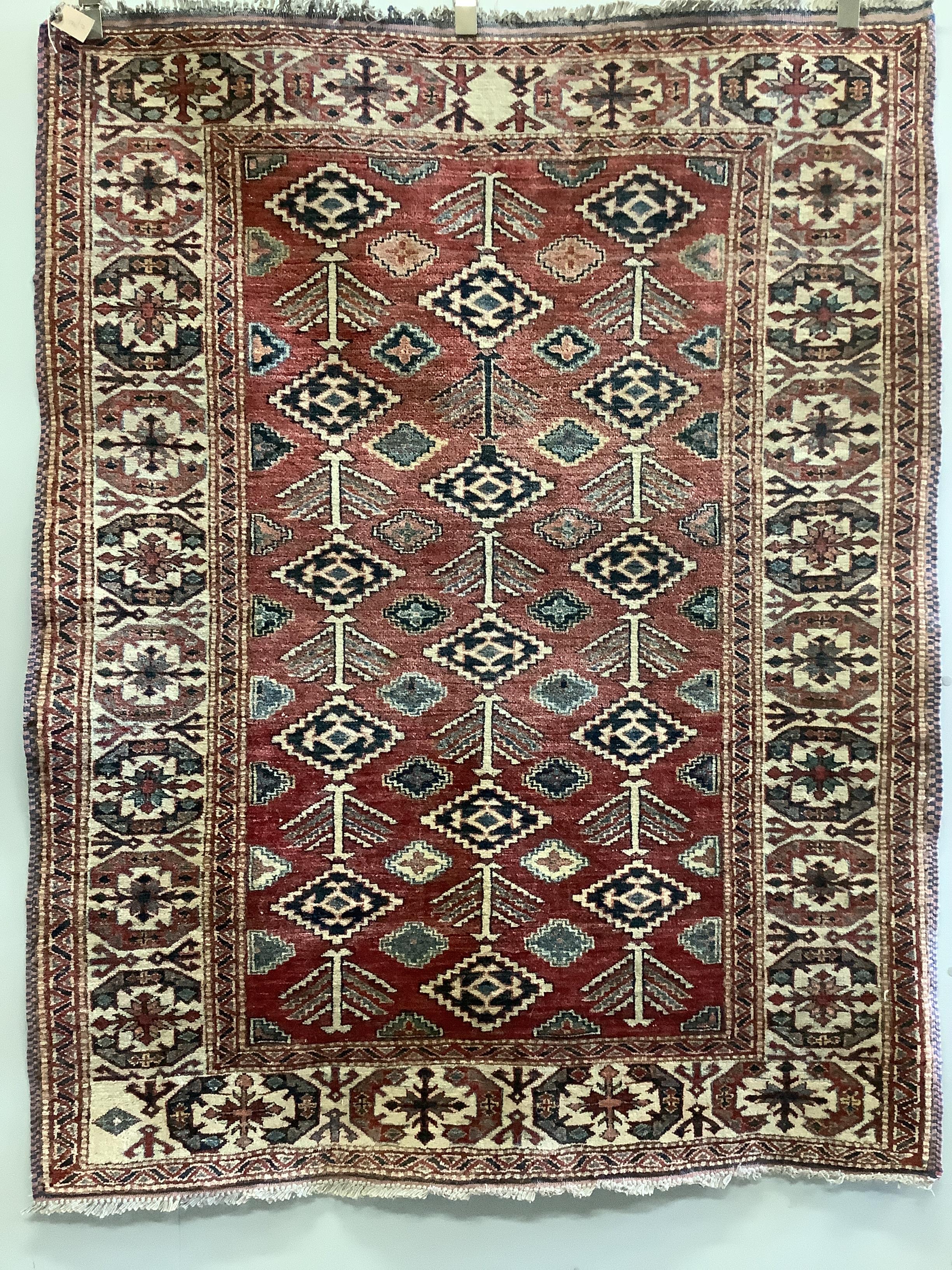 A Caucasian style red ground rug, 170 x 143cm